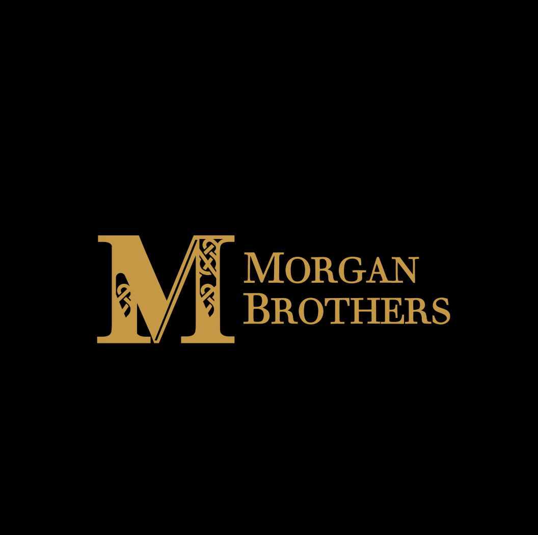 Logo for Morgan Brothers, featuring a large gold letter M with ornate decorative details, and the words 'Morgan Brothers' in gold text on a black background.